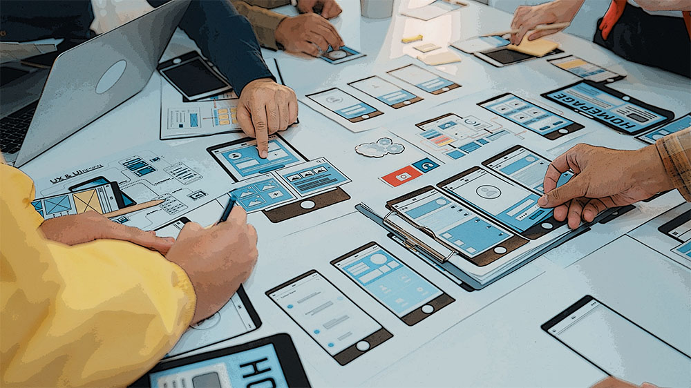 A team reviewing a user interface on a large screen